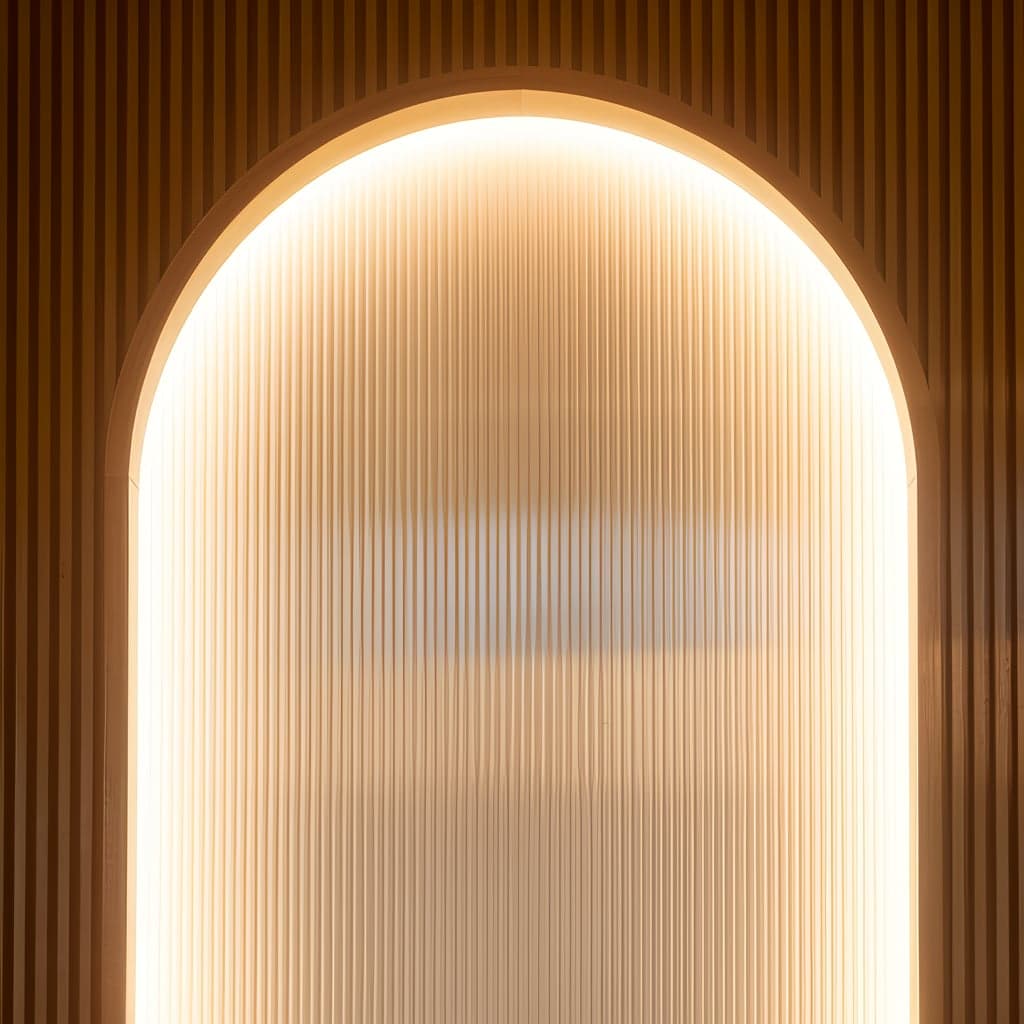 The backlit arch against a slatted backdrop.